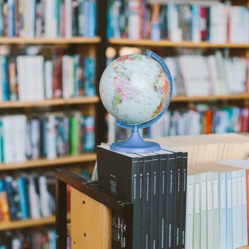 Canva - Photo Of Globe On Top Of Books