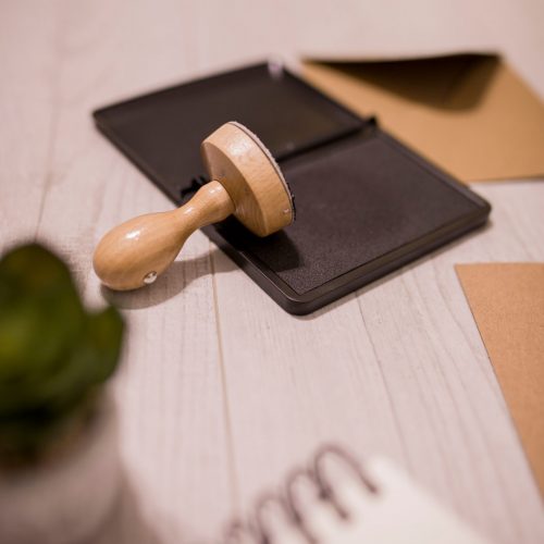 Canva - Wooden stamp on ink pad placed on desk